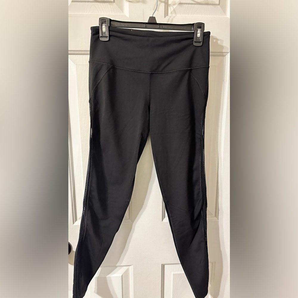 Victoria Sport high rise leggings/yoga pants with cutout detail on legs.